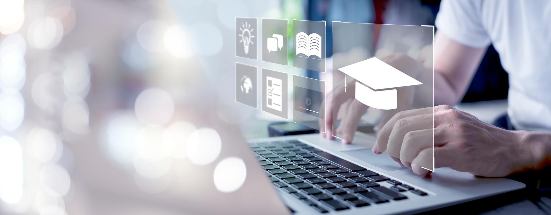 Laptop mit digitalen Lernsymbolen | online Seminarverwaltung