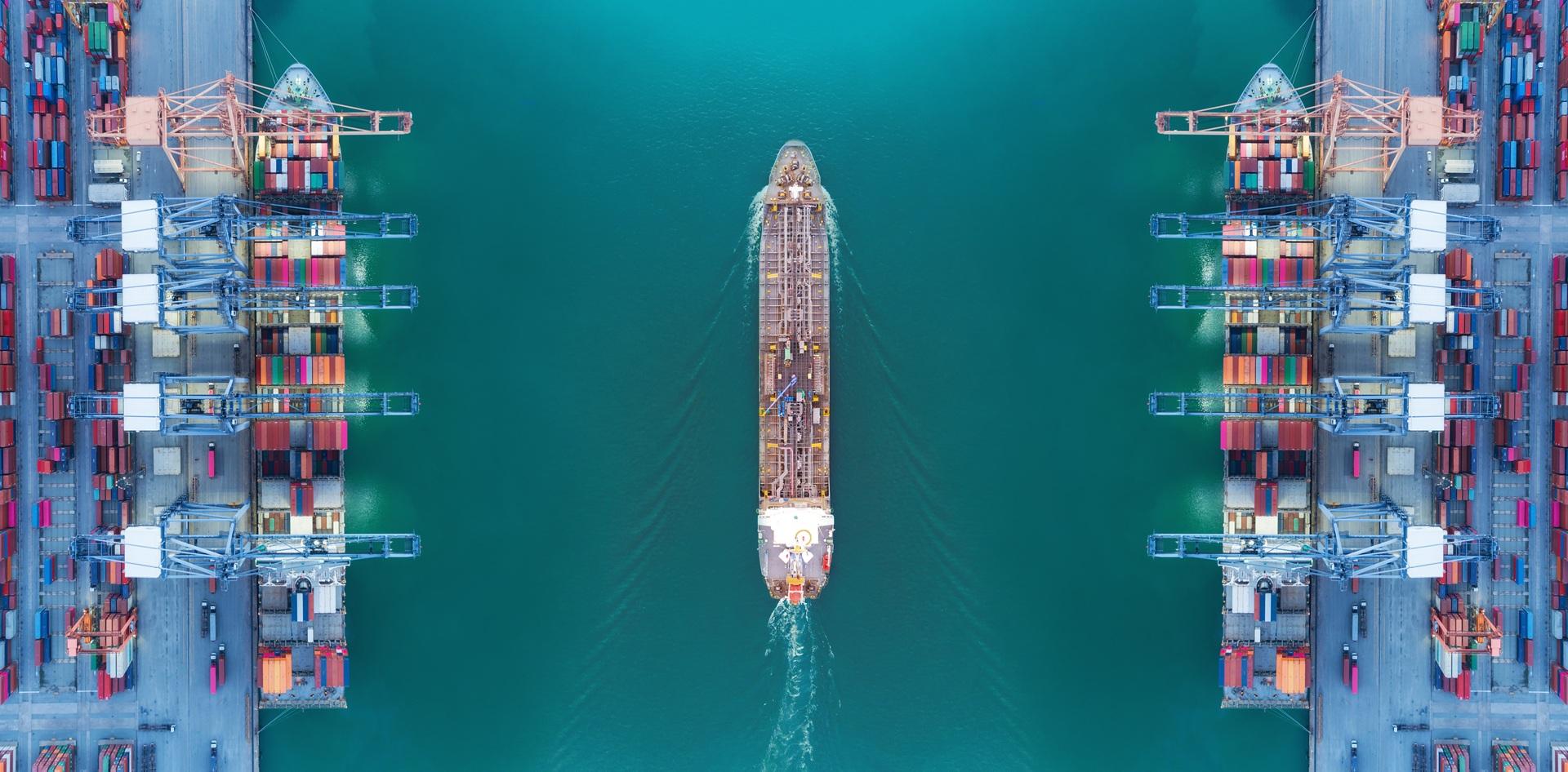 Luftaufnahme eines Schiffes zwischen Containerbrücken | Digitalisierung Hafen